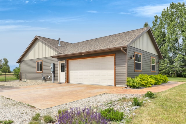109 Como Vista Ln, Hamilton, MT 59840 - view of front facade featuring board and batten siding, driveway, a garage, and roof with shingles