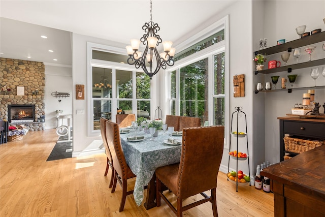 20245 Swan View Rd, Rollins, MT 59931 - dining area featuring a chandelier, light wood finished floors, a fireplace, and recessed lighting