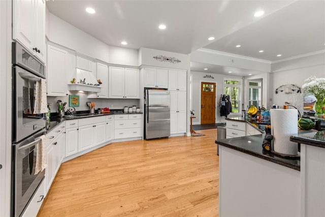 20245 Swan View Rd, Rollins, MT 59931 - kitchen featuring appliances with stainless steel finishes, light wood-type flooring, recessed lighting, white cabinetry, and crown molding