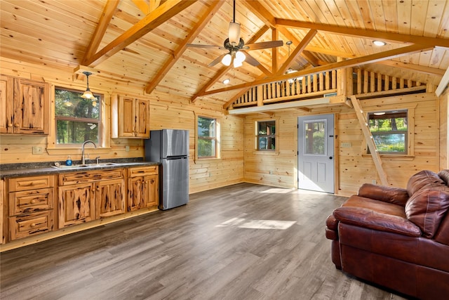 20245 Swan View Rd, Rollins, MT 59931 - kitchen with freestanding refrigerator, open floor plan, dark countertops, wood ceiling, and wood walls