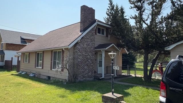 415 W 3rd St, Whitefish, MT 59937 - view of side of home featuring a chimney