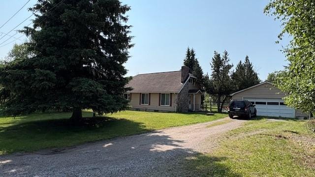415 W 3rd St, Whitefish, MT 59937 - view of front of property featuring a front lawn, a chimney, and a detached garage