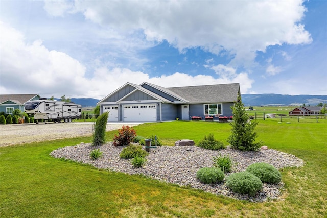 4460 Sunburst Ln, Stevensville, MT 59870 - view of front of property with board and batten siding, driveway, an attached garage, and a mountain view