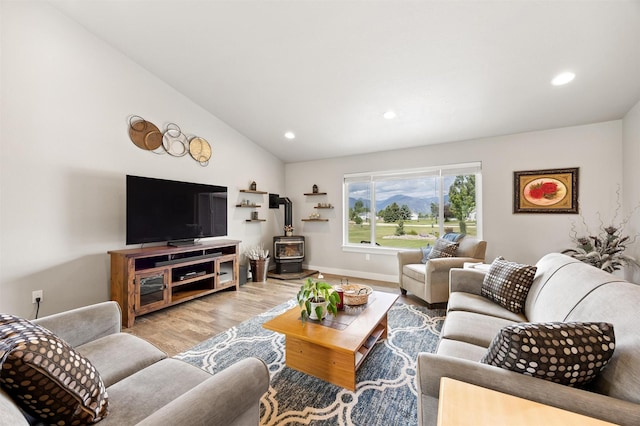 4460 Sunburst Ln, Stevensville, MT 59870 - living room with a wood stove, vaulted ceiling, wood finished floors, and recessed lighting