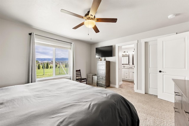 4460 Sunburst Ln, Stevensville, MT 59870 - bedroom with light colored carpet, ensuite bath, and ceiling fan