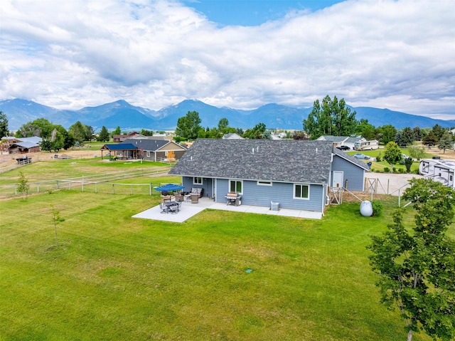 4460 Sunburst Ln, Stevensville, MT 59870 - rear view of house with a patio area, a mountain view, and a fenced backyard