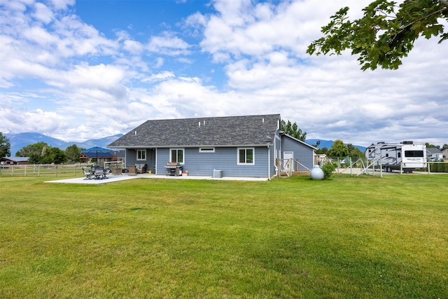 4460 Sunburst Ln, Stevensville, MT 59870 - back of property with a patio, a mountain view, and a shingled roof