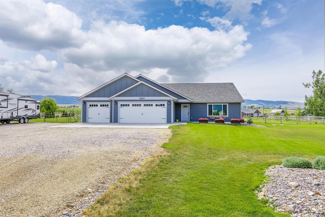 4460 Sunburst Ln, Stevensville, MT 59870 - view of front of home with board and batten siding, driveway, an attached garage, and a shingled roof