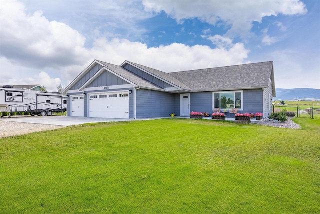 4460 Sunburst Ln, Stevensville, MT 59870 - view of front of property with board and batten siding, driveway, roof with shingles, and an attached garage