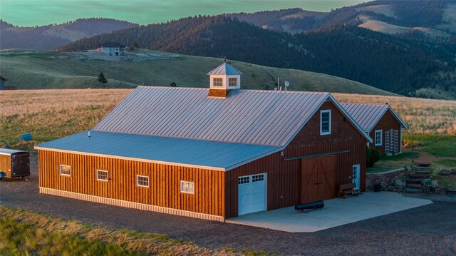 5325 Elk Ridge Rd, Helena, MT 59601 - view of front facade with a detached garage, a mountain view, an outbuilding, and a metal roof