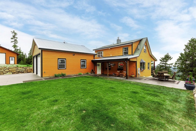 185 Peak Rd, Bozeman, MT 59715 - back of house featuring a yard, a chimney, a detached garage, and an outbuilding