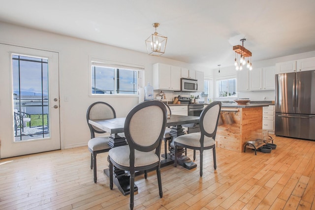 205 Kolczak Ln, Townsend, MT 59644 - dining space with a chandelier and light wood-style flooring