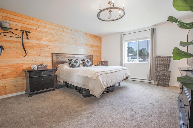 205 Kolczak Ln, Townsend, MT 59644 - bedroom with wood walls, carpet floors, a baseboard radiator, and a chandelier
