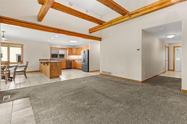 103 Crescent Lndg, Polson, MT 59860 - kitchen featuring appliances with stainless steel finishes, beam ceiling, light tile patterned flooring, light carpet, and open floor plan