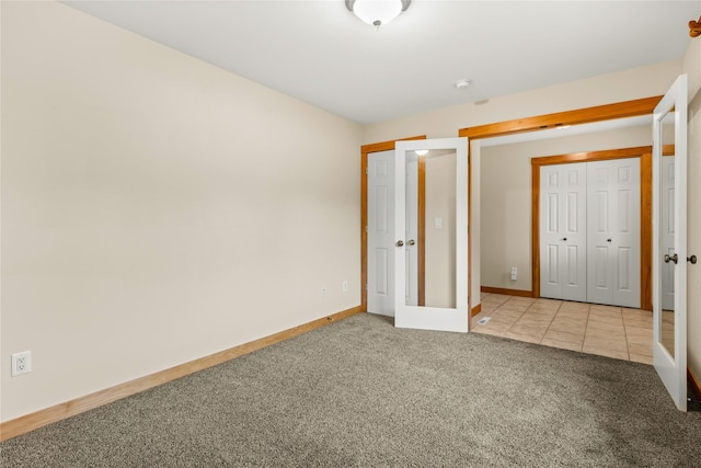 103 Crescent Lndg, Polson, MT 59860 - unfurnished bedroom with light colored carpet, a closet, and light tile patterned floors