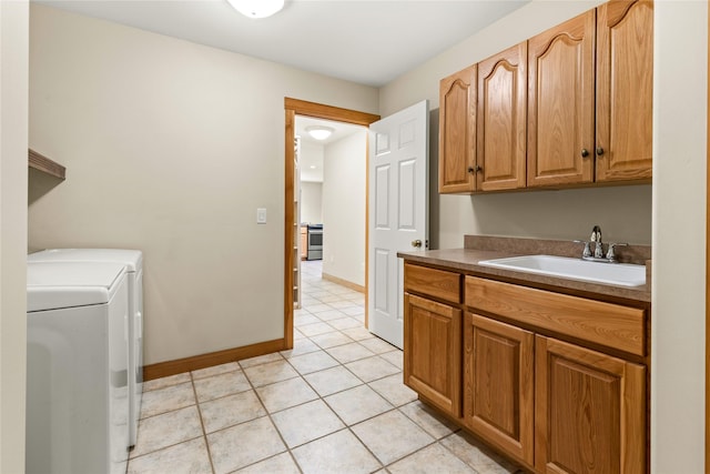 103 Crescent Lndg, Polson, MT 59860 - washroom featuring separate washer and dryer, cabinet space, and light tile patterned floors