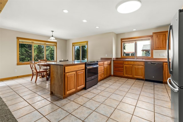 103 Crescent Lndg, Polson, MT 59860 - kitchen featuring appliances with stainless steel finishes, light tile patterned floors, recessed lighting, brown cabinets, and decorative light fixtures