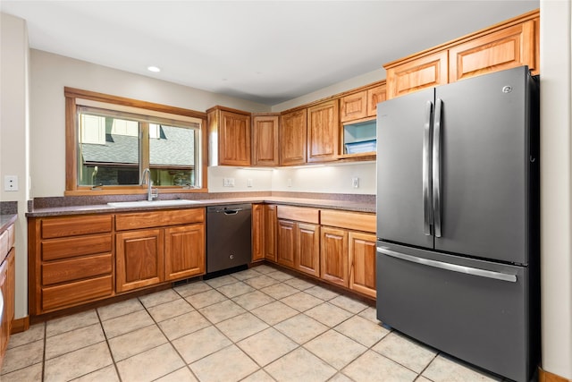 103 Crescent Lndg, Polson, MT 59860 - kitchen featuring appliances with stainless steel finishes, light tile patterned floors, recessed lighting, brown cabinets, and dark countertops
