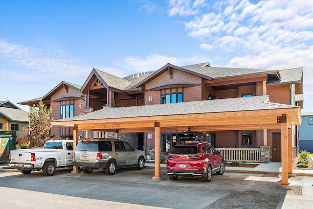 NHN Shiloh Ave Unit 1-16, Whitefish, MT 59937 - townhome / multi-family property featuring covered parking, roof with shingles, and stone siding