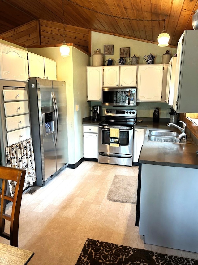645 Morrell Creek Dr, Seeley Lake, MT 59868 - kitchen with stainless steel appliances, wood ceiling, dark countertops, white cabinets, and decorative light fixtures