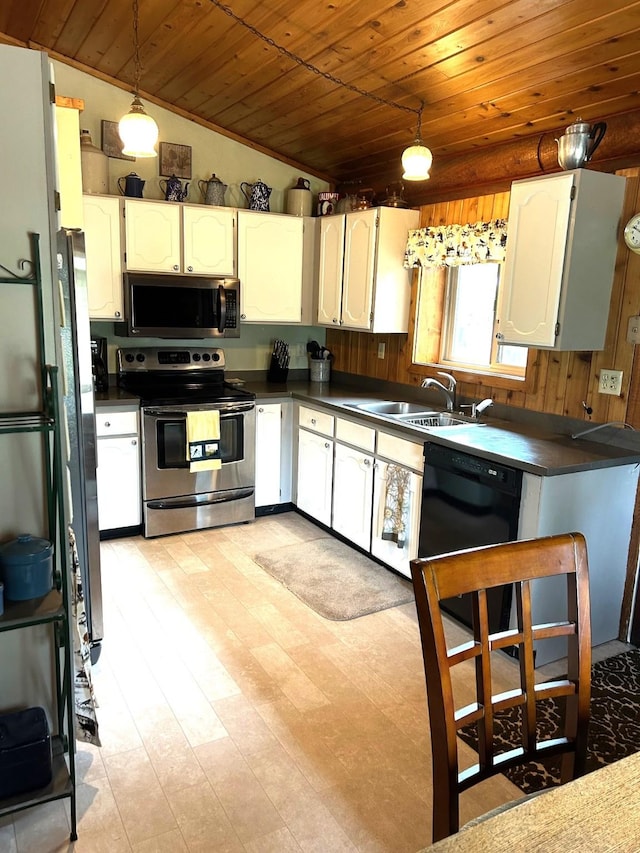 645 Morrell Creek Dr, Seeley Lake, MT 59868 - kitchen featuring appliances with stainless steel finishes, wood ceiling, dark countertops, white cabinetry, and vaulted ceiling