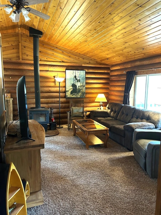 645 Morrell Creek Dr, Seeley Lake, MT 59868 - carpeted living area with wooden ceiling, a wood stove, ceiling fan, and rustic walls