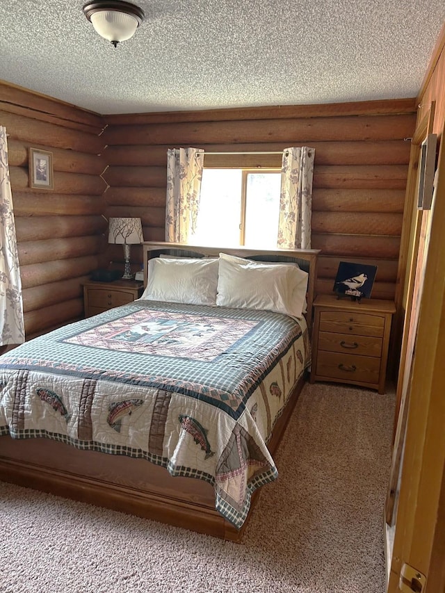 645 Morrell Creek Dr, Seeley Lake, MT 59868 - bedroom with a textured ceiling, carpet flooring, and log walls