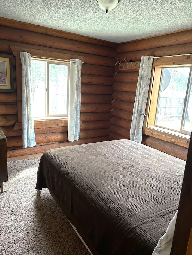 645 Morrell Creek Dr, Seeley Lake, MT 59868 - carpeted bedroom featuring a textured ceiling and log walls