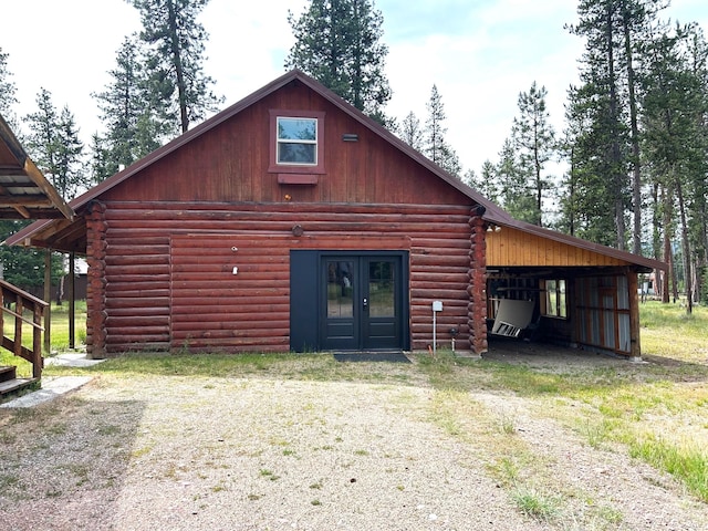 645 Morrell Creek Dr, Seeley Lake, MT 59868 - view of front facade with log siding and french doors
