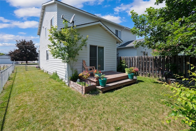1483 Western Dr, Kalispell, MT 59901 - back of house with a fenced backyard and a deck