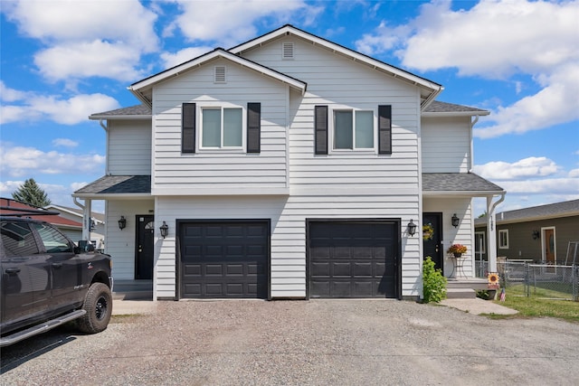 1483 Western Dr, Kalispell, MT 59901 - view of front of house with gravel driveway, a garage, and a shingled roof