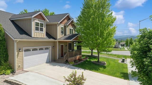 101 Heavens Peak Dr, Kalispell, MT 59901 - view of front of house featuring driveway, a front lawn, a porch, roof with shingles, and a mountain view