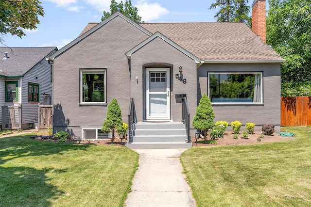 546 Woodworth Ave, Missoula, MT 59801 - view of front of house with a chimney, a shingled roof, and stucco siding