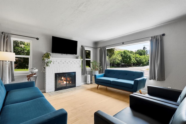 546 Woodworth Ave, Missoula, MT 59801 - living room featuring a fireplace, a textured ceiling, and wood finished floors