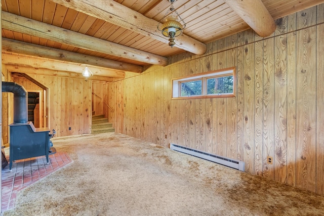 581 Timber Trl, Stevensville, MT 59870 - spare room with baseboard heating, a wooden ceiling with exposed beams, a wood stove, stairway, and carpet floors