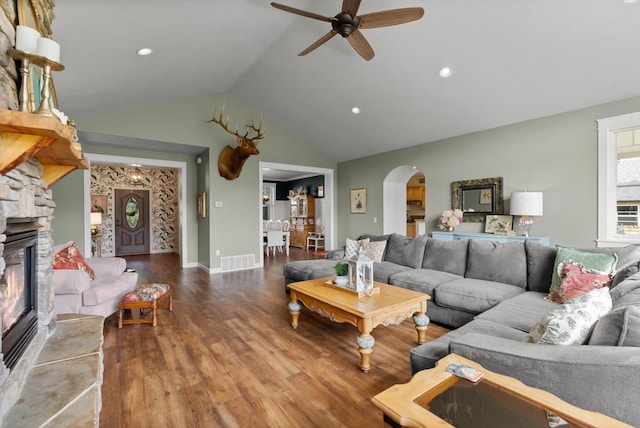 451 Creston Hatchery Rd, Kalispell, MT 59901 - living area featuring arched walkways, a ceiling fan, lofted ceiling, wood finished floors, and a fireplace