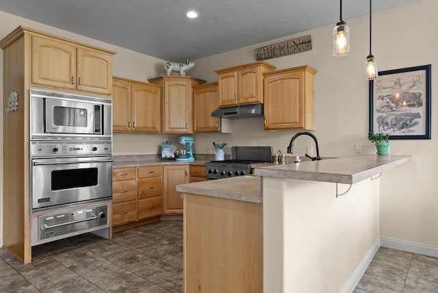 451 Creston Hatchery Rd, Kalispell, MT 59901 - kitchen featuring appliances with stainless steel finishes, under cabinet range hood, a warming drawer, light brown cabinets, and a peninsula