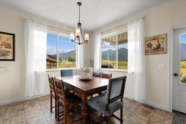 451 Creston Hatchery Rd, Kalispell, MT 59901 - dining space featuring a chandelier, plenty of natural light, and a mountain view