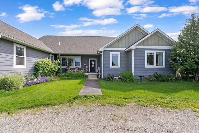 451 Creston Hatchery Rd, Kalispell, MT 59901 - view of front facade with board and batten siding, a porch, and a front yard