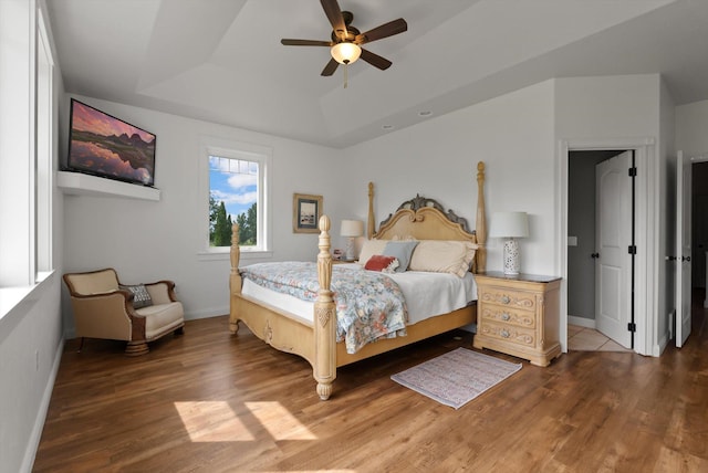 451 Creston Hatchery Rd, Kalispell, MT 59901 - bedroom featuring a tray ceiling, wood finished floors, and a ceiling fan