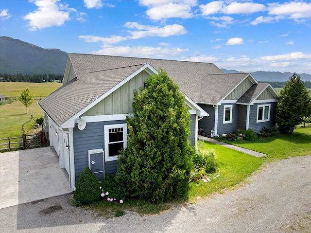 451 Creston Hatchery Rd, Kalispell, MT 59901 - view of front of house with board and batten siding, a mountain view, and a shingled roof