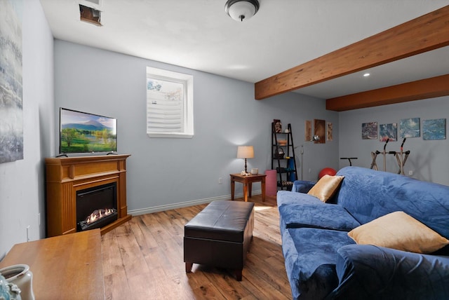 451 Creston Hatchery Rd, Kalispell, MT 59901 - living room featuring wood finished floors, a glass covered fireplace, and beamed ceiling