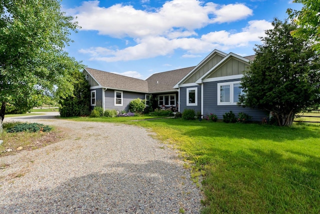 451 Creston Hatchery Rd, Kalispell, MT 59901 - ranch-style house with board and batten siding, driveway, a front lawn, and roof with shingles
