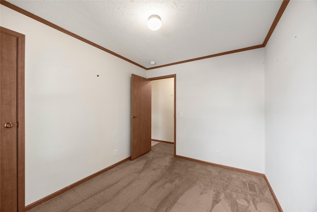 1100 E Oregon St Unit 13, Kalispell, MT 59901 - empty room featuring light carpet, ornamental molding, and a textured ceiling