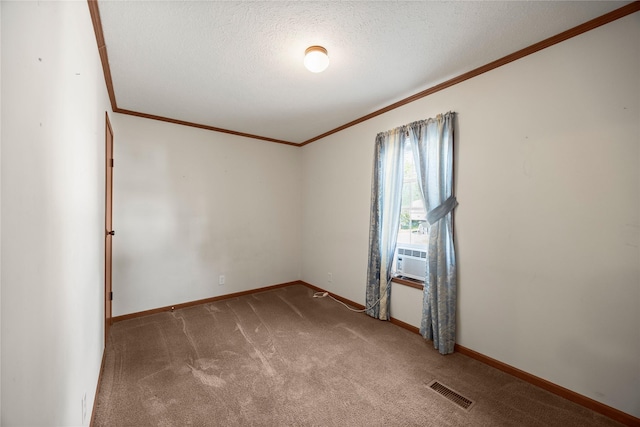 1100 E Oregon St Unit 13, Kalispell, MT 59901 - unfurnished room featuring ornamental molding, carpet flooring, cooling unit, and a textured ceiling