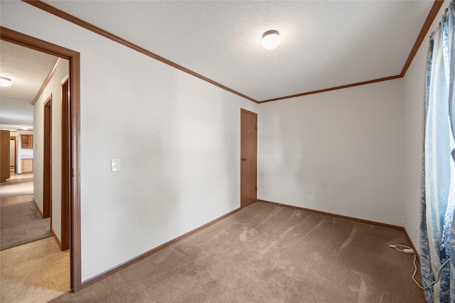 1100 E Oregon St Unit 13, Kalispell, MT 59901 - spare room featuring light carpet, a textured ceiling, and ornamental molding