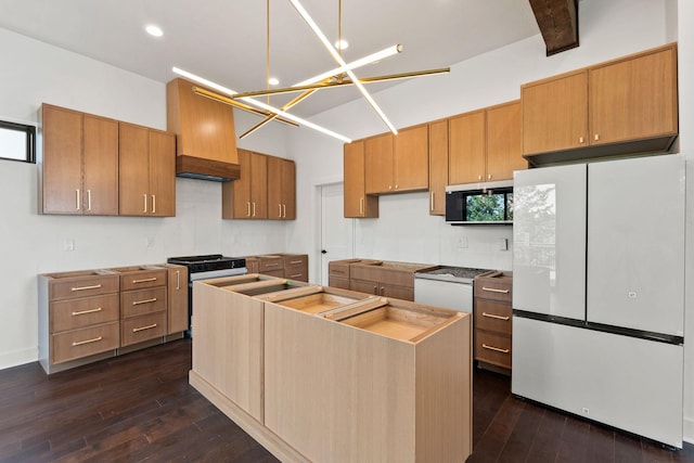 211 Whisper Ridge Dr, Bigfork, MT 59911 - kitchen featuring appliances with stainless steel finishes, dark wood-type flooring, a kitchen island, premium range hood, and recessed lighting