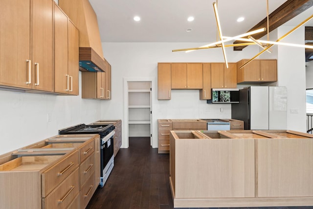 211 Whisper Ridge Dr, Bigfork, MT 59911 - kitchen featuring stainless steel range with gas stovetop, freestanding refrigerator, dark wood-type flooring, custom exhaust hood, and recessed lighting
