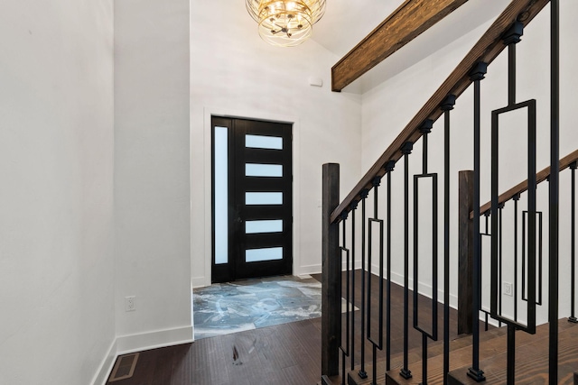 211 Whisper Ridge Dr, Bigfork, MT 59911 - foyer entrance featuring a chandelier, stairway, wood finished floors, a towering ceiling, and beam ceiling