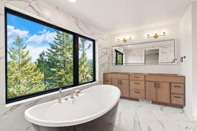 211 Whisper Ridge Dr, Bigfork, MT 59911 - bathroom featuring marble finish floors, vanity, and a freestanding bath